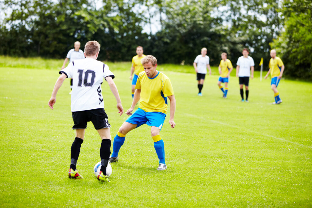 Adults playing soccer